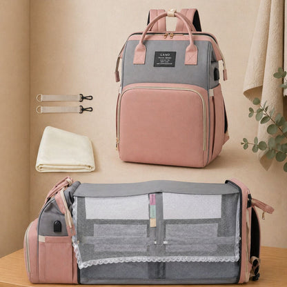 Sac à dos à langer Nid Nomade avec lit intégré déplié pour bébé couleur rose et gris 