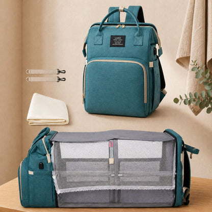 Sac à dos à langer Nid Nomade avec lit intégré déplié en position couchage bébé couleur vert