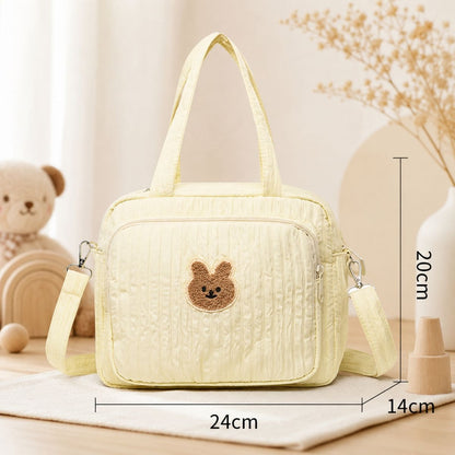 Sac à langer Petit Câlin beige avec dimensions 24 × 14 × 20 cm